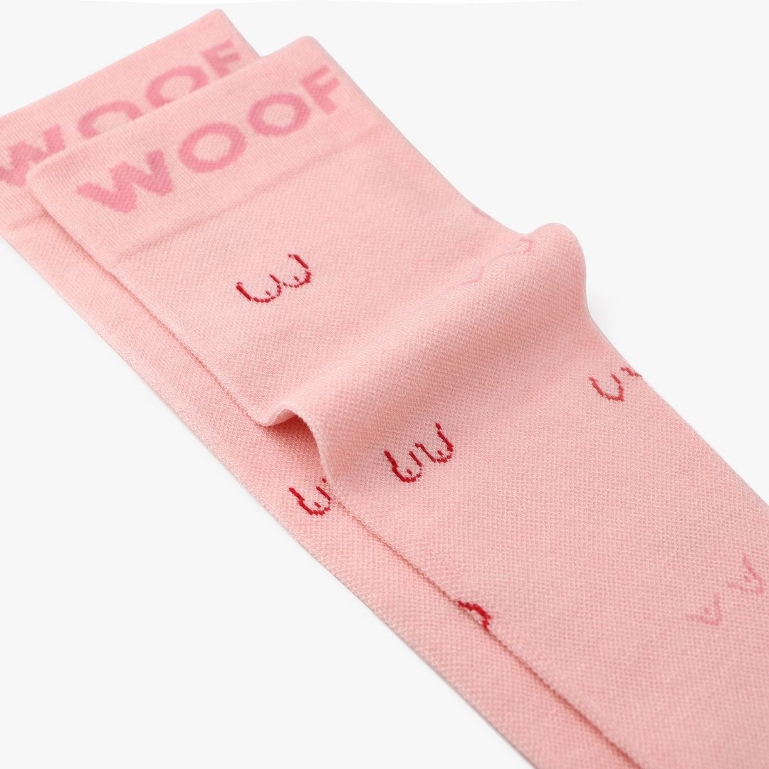 Folded view showing line art boobs print on pink compression socks.